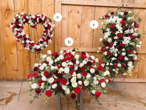 The Watering Can | A matching red and white easel spray, casket spray, and heart for a bereavement.