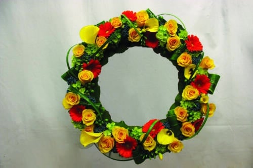 The Watering Can | An orange and yellow bereavement wreath.