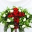 The Watering Can | A rounded green and white casket spray with a cross of red flowers acorss the centre.