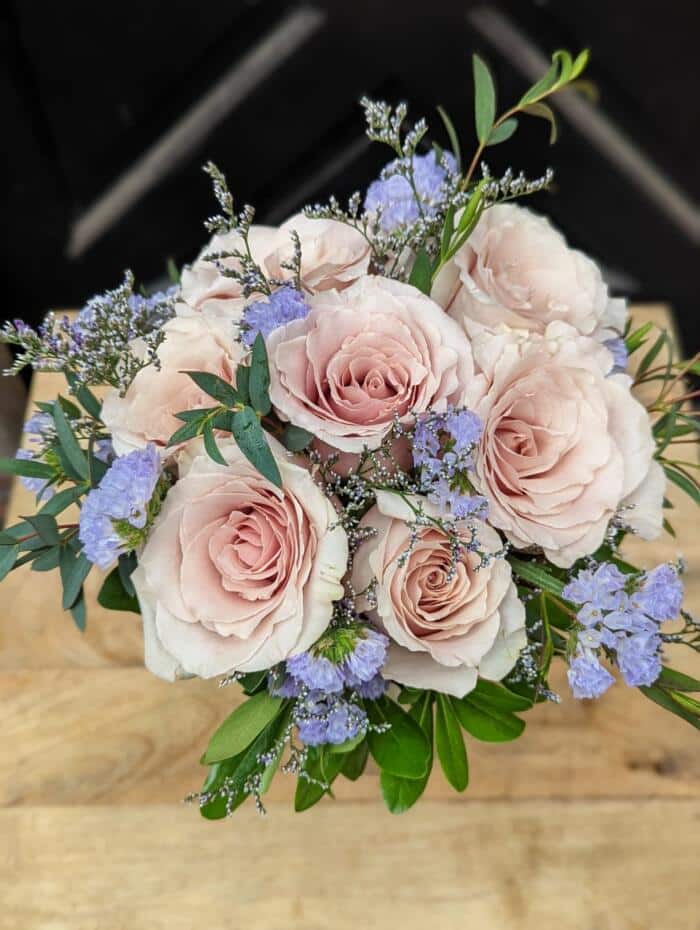 The Watering Can | A small bouquet of blush roses with blue statice, limonium and minimal greenery.