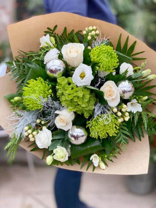 The Watering Can | A white and green hand-tied bouquet with silver balls.