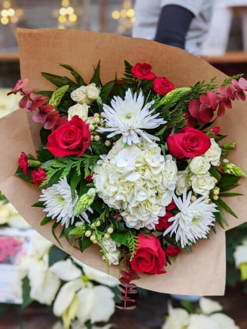 The Watering Can | A white and red hand tied bouquet.