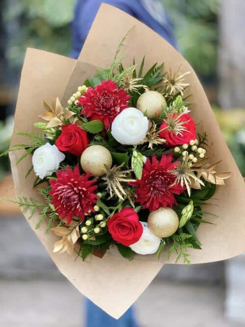 The Watering Can | A red, white and gold hand-tied bouquet.
