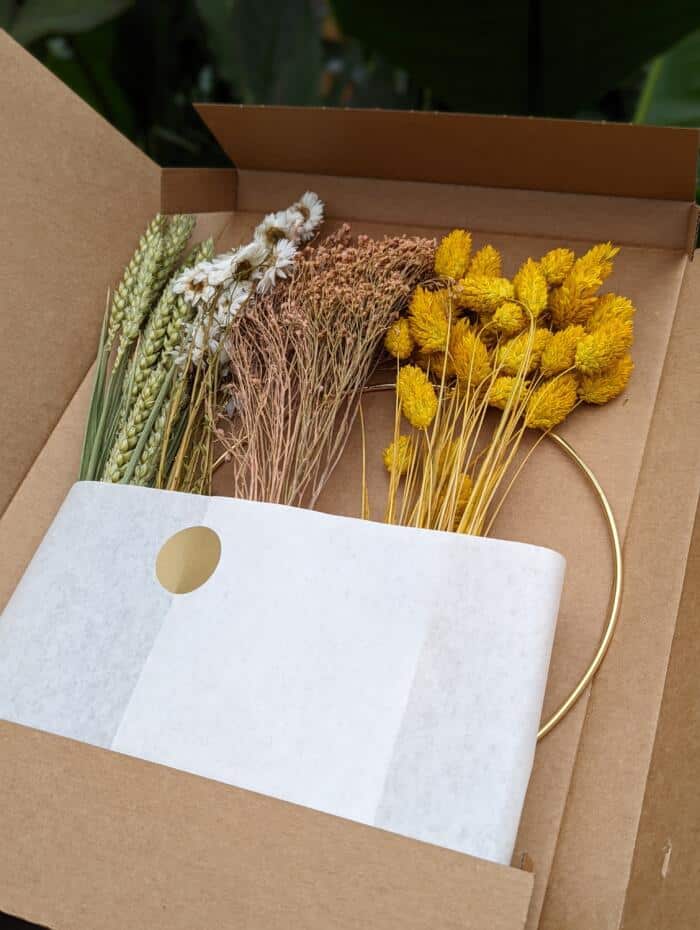 The Watering Can | The kit as it comes. Dried wheat, flowers and the golden hoop wrapped in a paper sleeve.