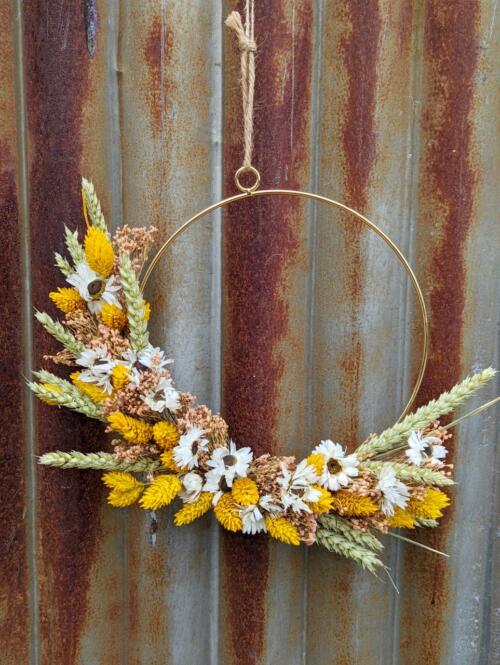 The Watering Can | A golden hoop with yellow, pink and white dried florals.