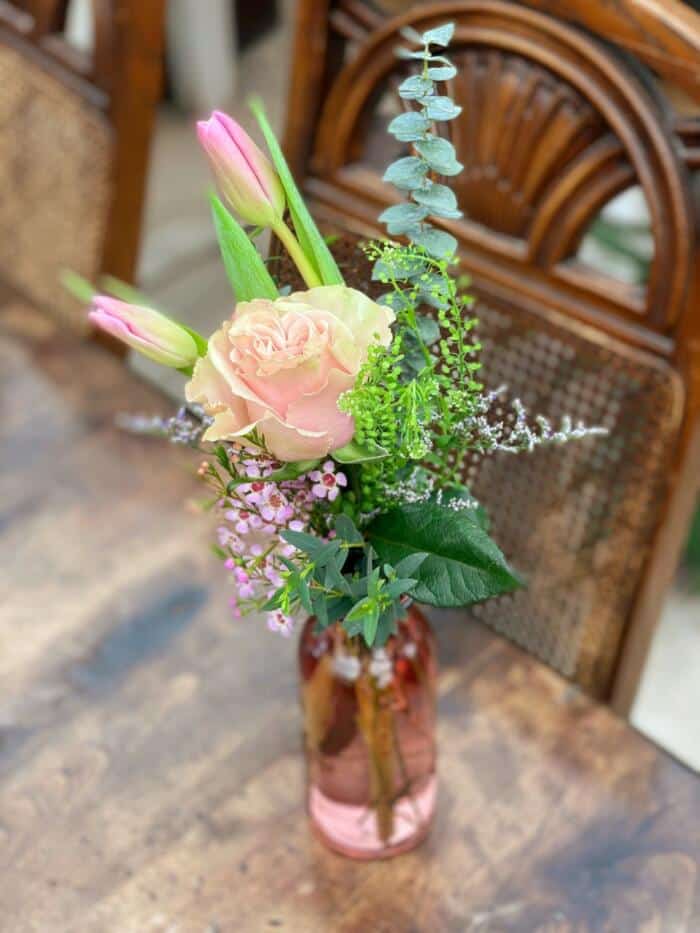 The Watering Can | A small pink bouquet in vase in a pink glass vase.