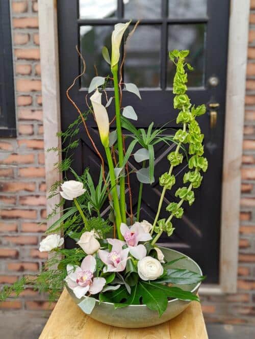 The Watering Can | An airy and tall European arrangement in whites, blush and green designed in a large shallow bowl.