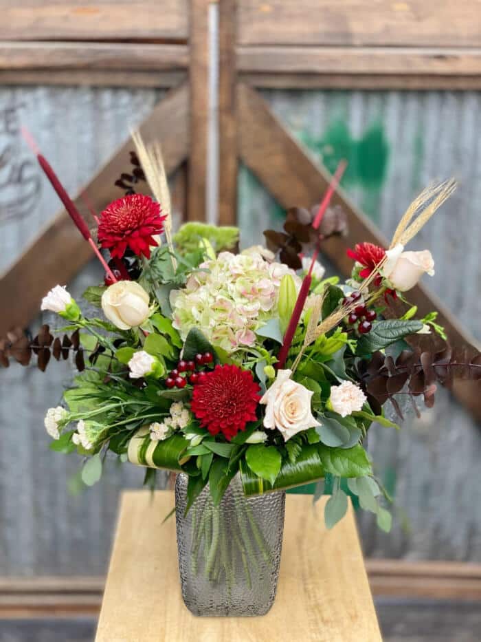 The Watering Can | A large burgundy and blush bouquet in a rectangular textured vase.