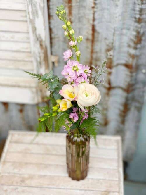 The Watering Can | Pink blooms in a tall bud vase.