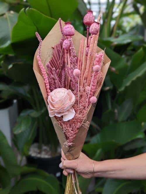 The Watering Can | A bundle of dried flowers in pink, and blush tones wrapped in brown paper.