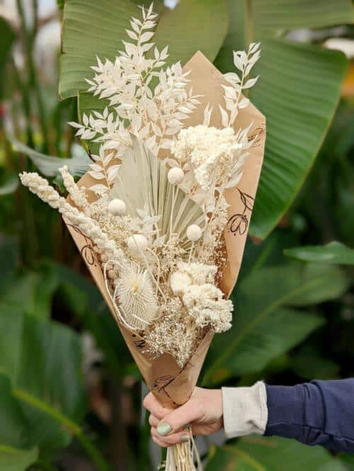 The Watering Can | A bundle of dried, bleached white flowers wrapped in brown paper.