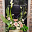 The Watering Can | A peach and white Euopean style arrangement with height in a white ceramic container.