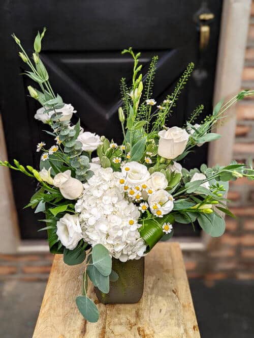 The Watering Can | A modern white and green bouquet in a grey glass vase.