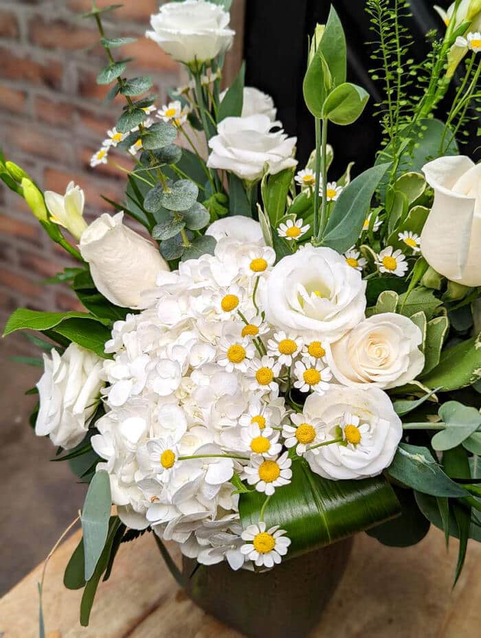 The Watering Can | Hydrangea, chamomile, and lisianthus in a modern white bouquet.