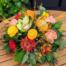 The Watering Can | A citrus coloured table centerpiece with dired wheat accents.