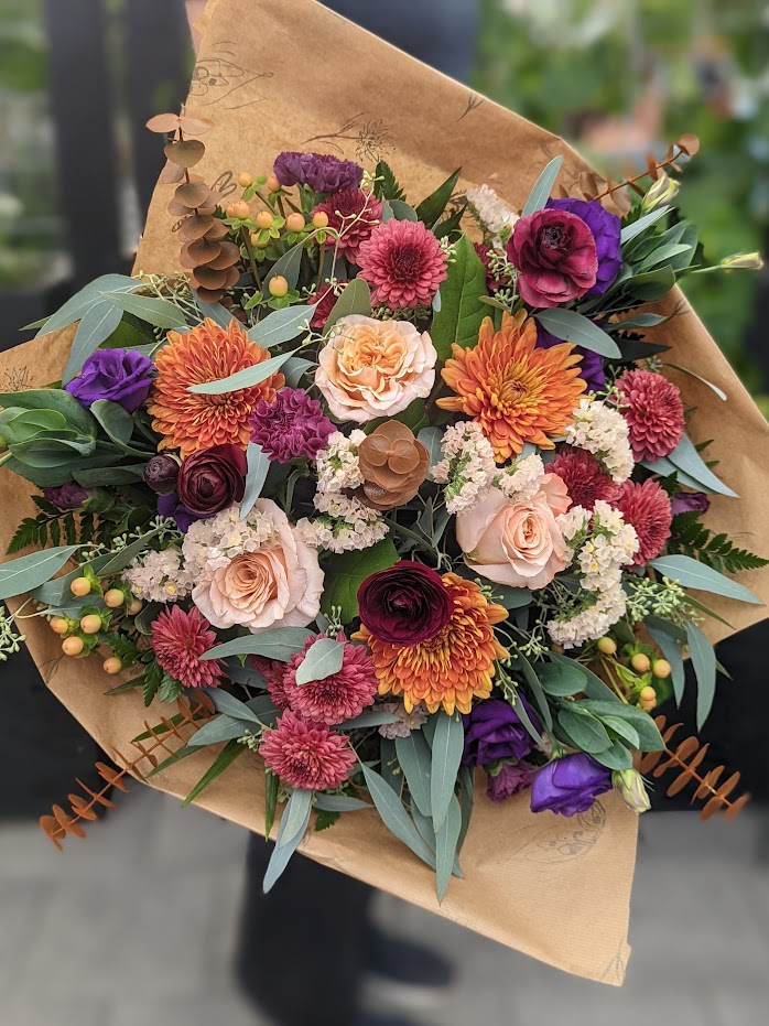 The Watering Can | A hand-tied bouquet in purples, carmel, burgundy, and blush.