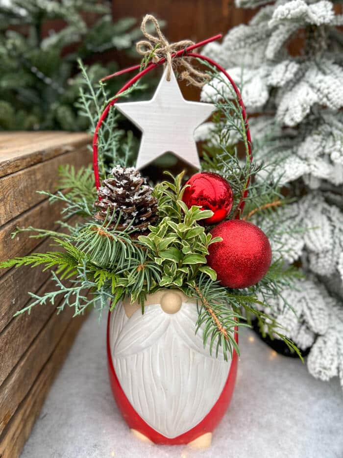 The Watering Can | This kit is made in a ceramic pot that resembles Santa! Inside of it you will design a festive arrangement with seasonal greens and decor.