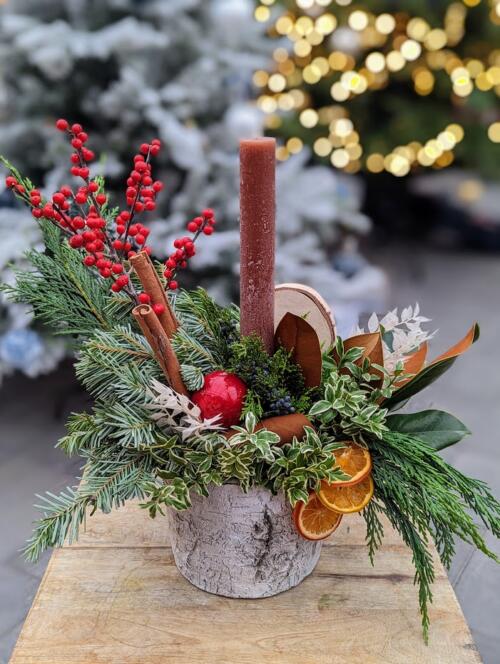The Watering Can | A winter festive arrangement featuring a brown taper candle and textured birch container.