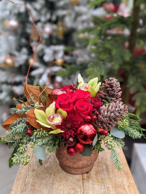 The Watering Can | A red and green festive European style arrangement in a copper coloured ceramic container.