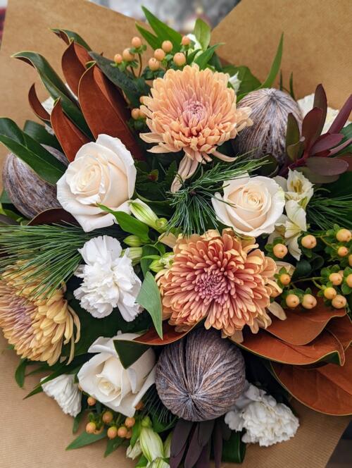 The Watering Can | champagne mums, white roses, and peach hypericum in a hand-tied bouquet.