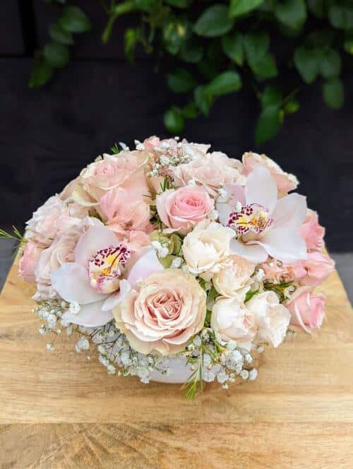 The Watering Can | A round mounded European style floral arrangement in soft whites and blush tones.