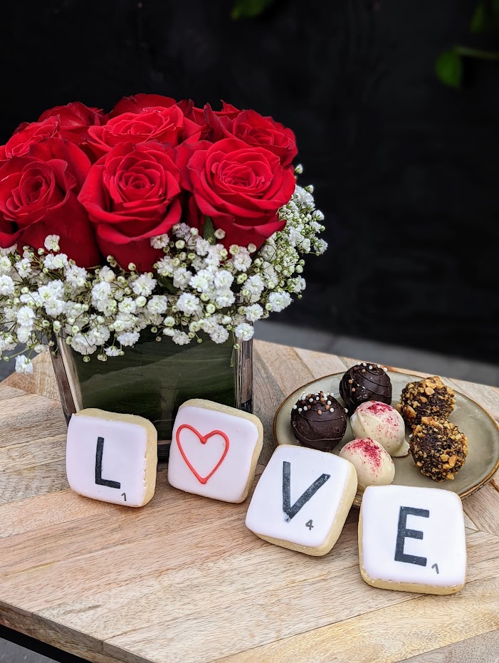 The Watering Can | A red rose bouquet, 4 small cookies that spell LOVE and a small plate with 6 assorted chocolate truffles.