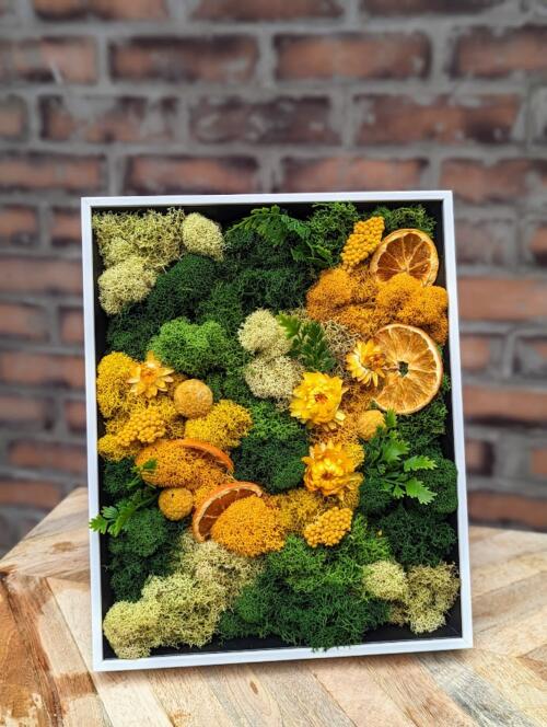 The Watering Can | Bright greens with a swirl of warm yellow and orange designed in a white frame.