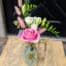 The Watering Can | A clear bud vase with pink and white flowers.