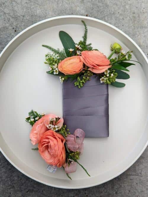 peach boutonniere and corsage featuring local peach ranunculus and light pink waxflower