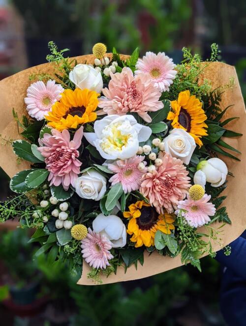 a sunset-esque bouquet. featuring local white peonies, blush mums, bright sunflowers, pink gerberas and more.