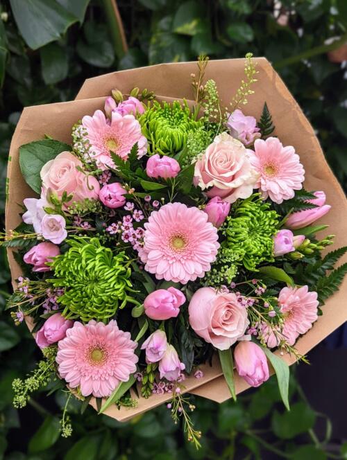 light pink gerberas, tulips and waxflower, green mums and more.