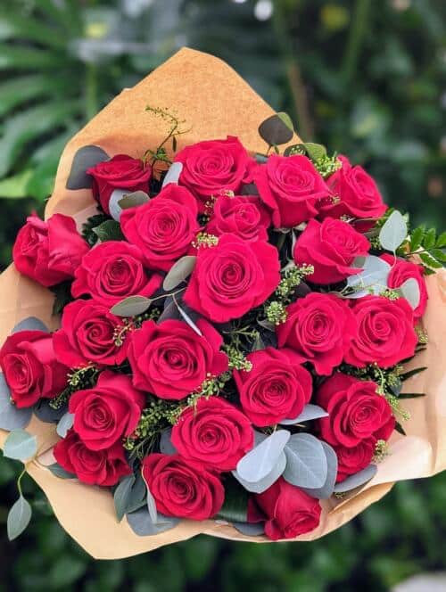 2 dozen red roses with fancy greenery